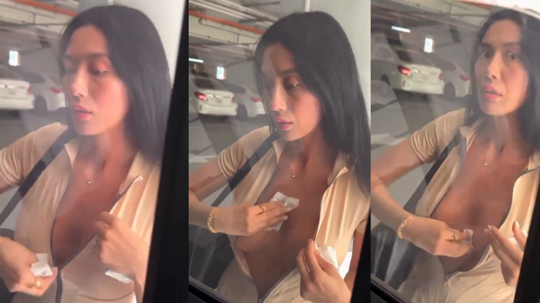 Woman wipes sweat off her tits in a parking